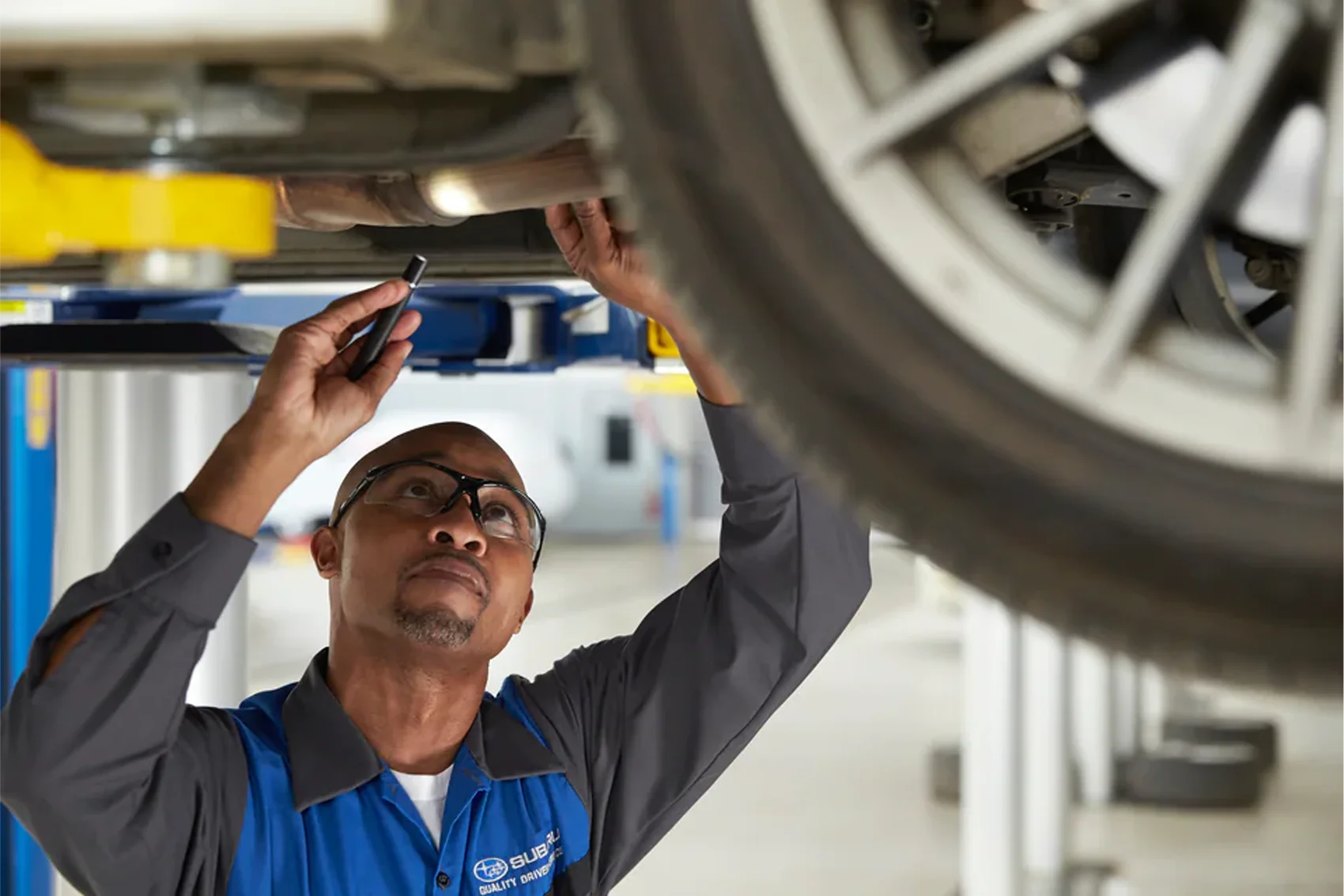 Subaru Tech looking under car