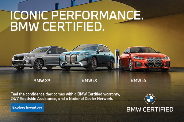 BMW Certified X3, iX, and i4 parked next to a colorful building wall.