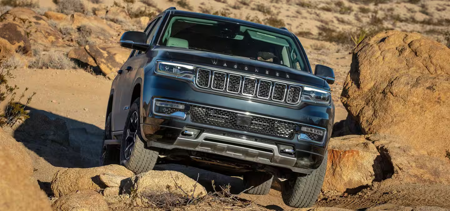 A black suv driving off-road.