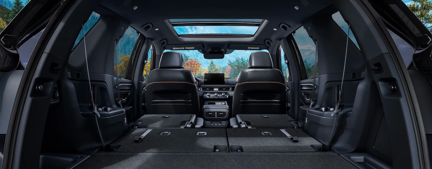 Interior cargo area of a 2025 Honda Pilot TrailSport with the seats folded down