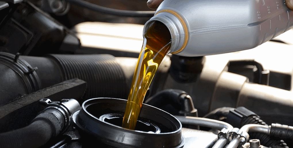 oil being poured into an RV reservoir during an oil change