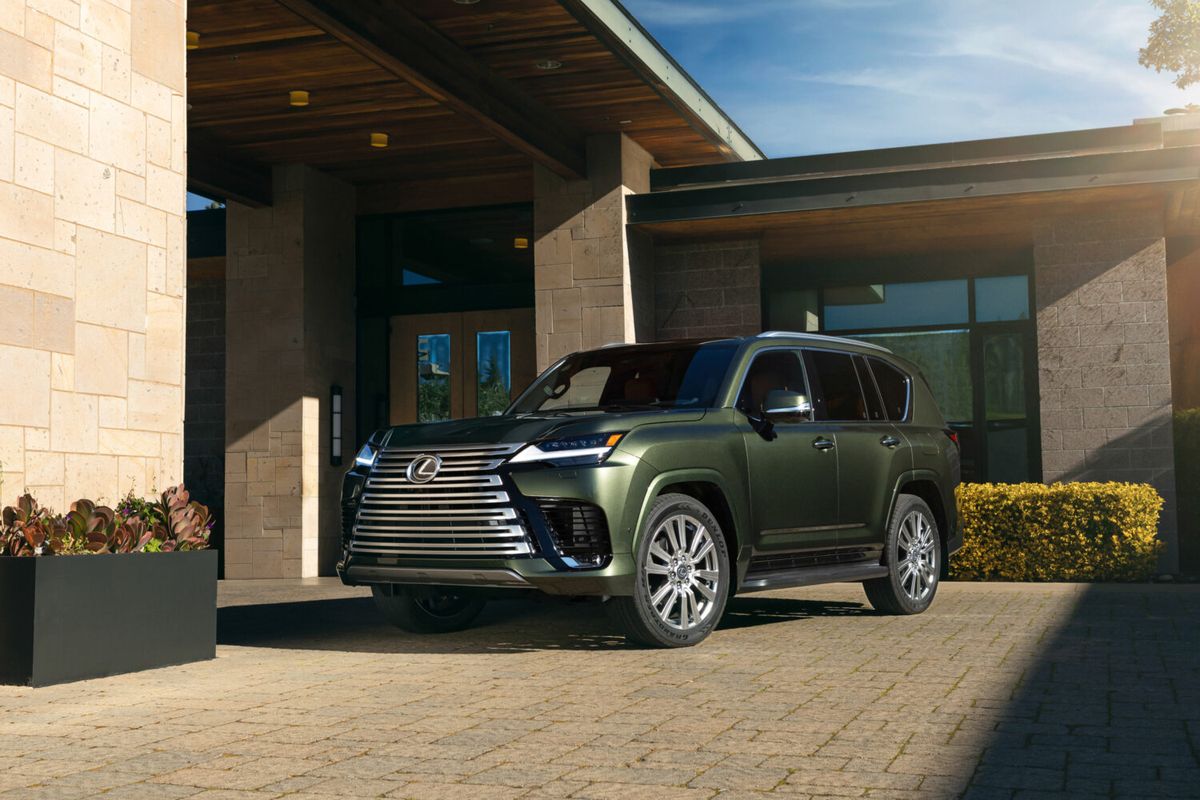 2026 Lexus LX 700h Ultra Luxury exterior in Nori Green Pearl, parked under a covered entryway