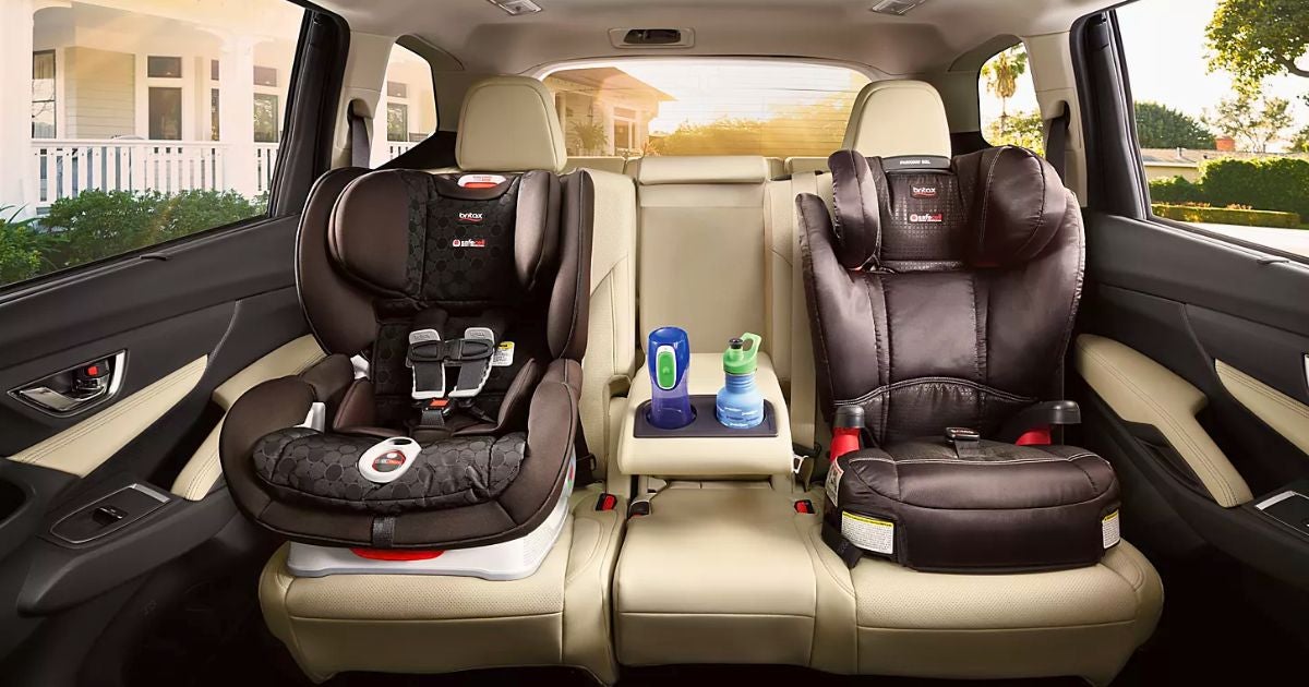 Two child car seats installed in the second-row seats of a Subaru Ascent with tan leather