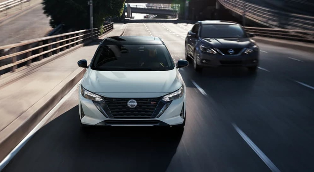 White 2025 Nissan Sentra SRs driving in a city