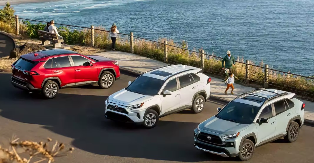 pictured left to right: red 2023 Toyota Rav4, white 2023 Toyota Rav4, light blue 2023 Toyota Rav4