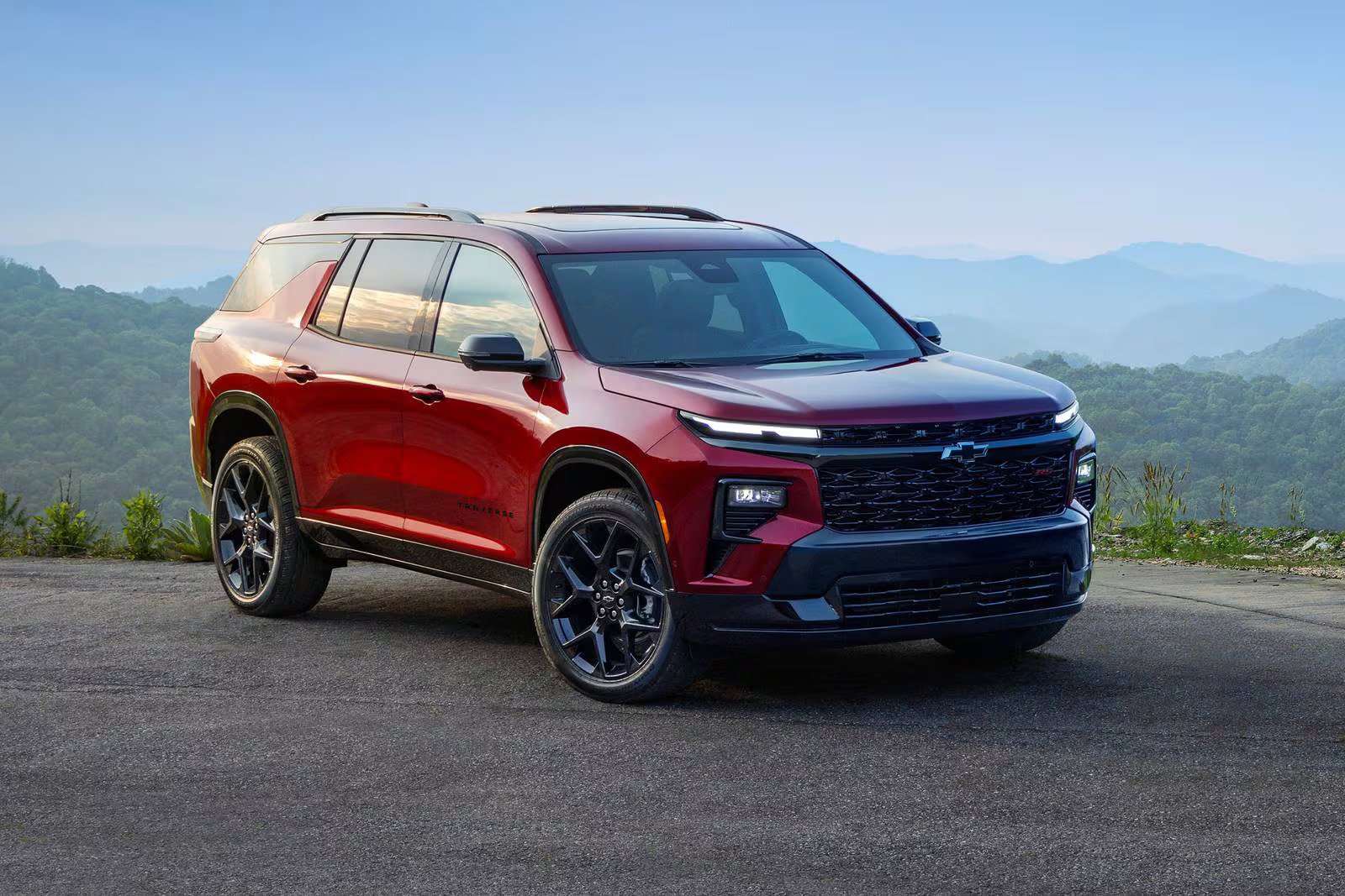 A red suv sitting parked on a road.