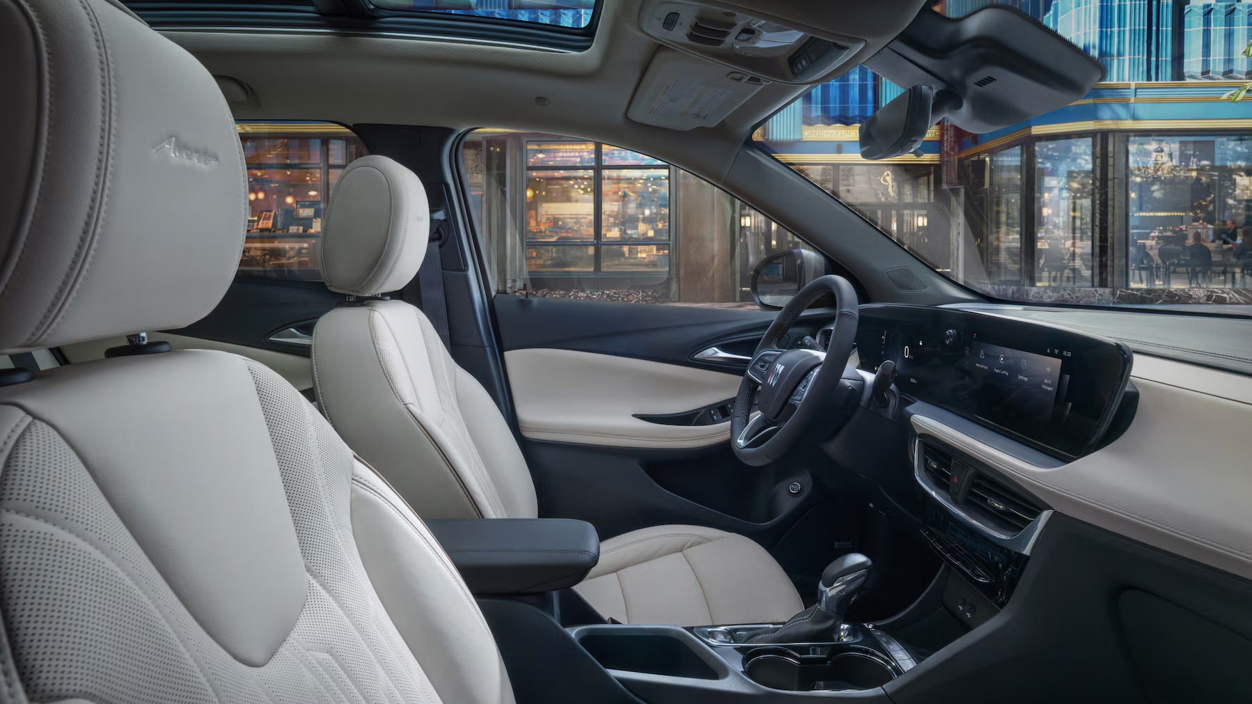 Buick Encore GX Avenir interior with light leather seats and a sunroof