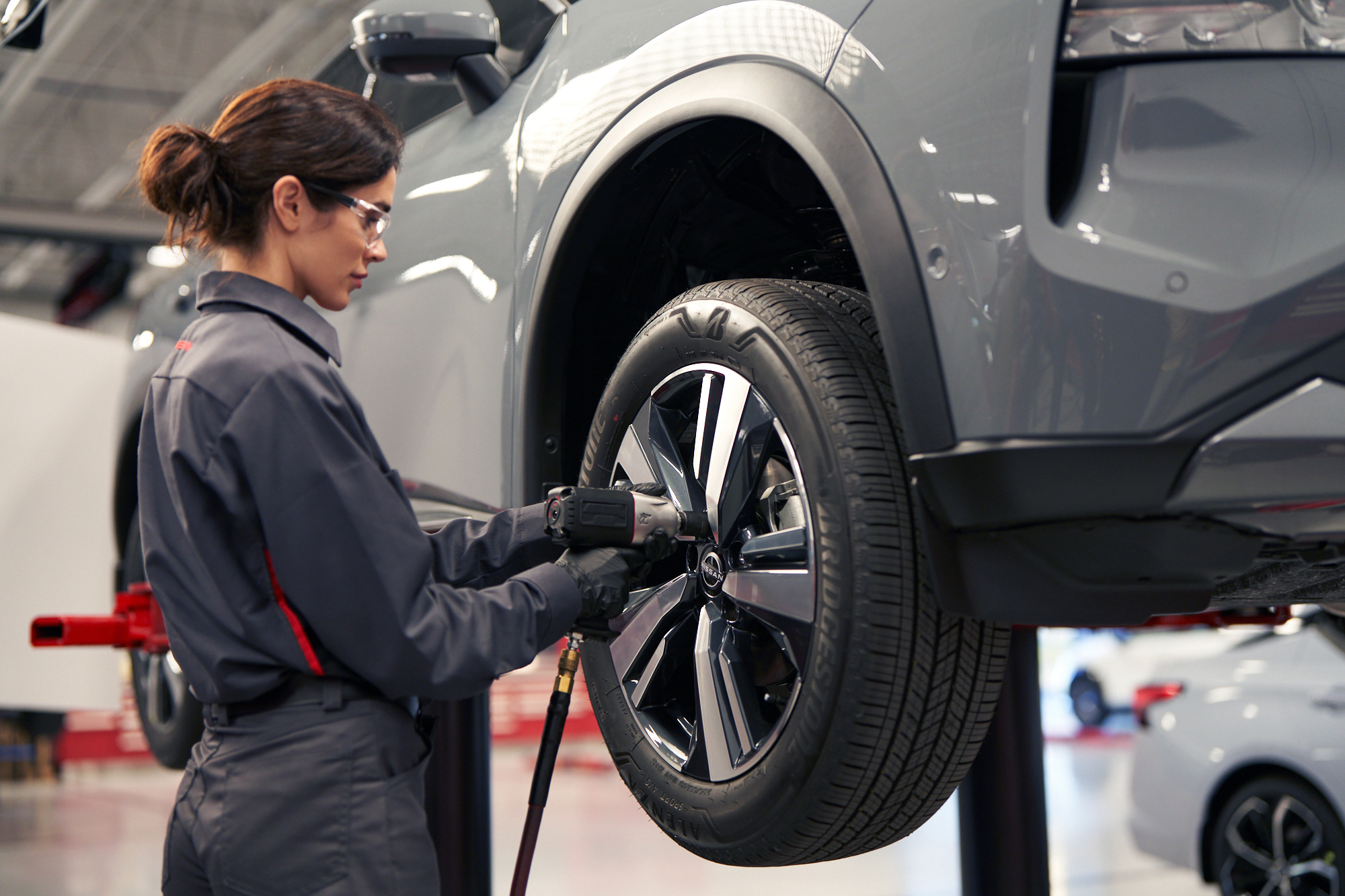 Technician working on a Nissan in an independent repair shop
