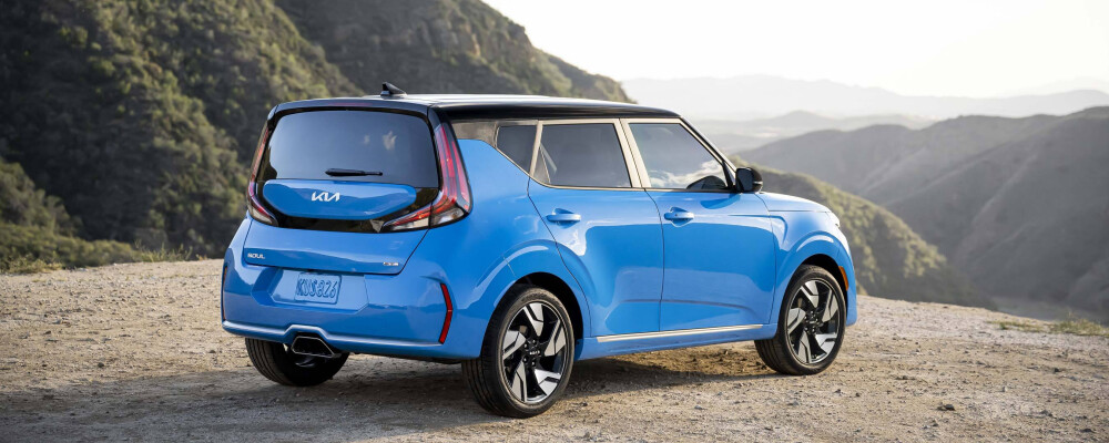 2023 Kia Soul in blue parked on a scenic overlook, showcasing modern design and sporty features, relevant to Kiefer Kia's trim level comparisons.