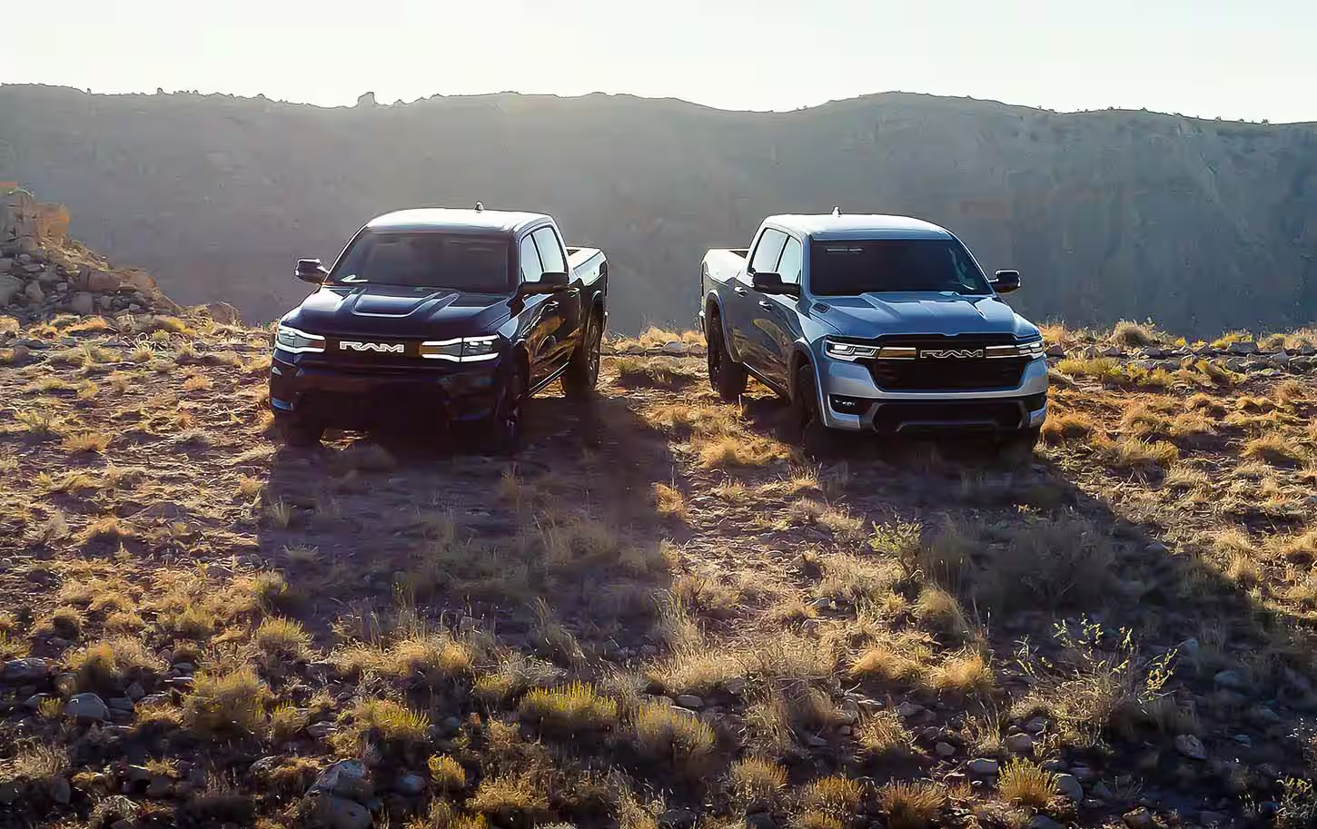 Two ram truck sitting parked by eachother.