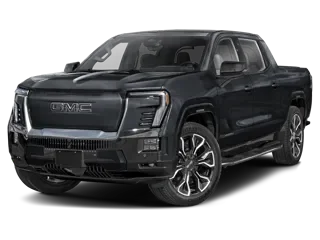 Front three-quarter studio view of a dark gray GMC electric pickup truck with a legible GMC nameplate on the closed-off front grille panel and black wheels, on a white background