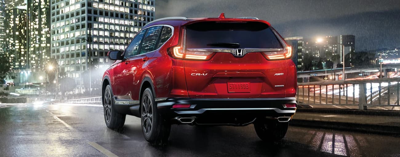 Red 2020 Honda CR-V Touring on a city street at night