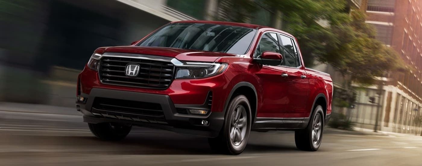 Red 2022 Honda Ridgeline RTL-E driving on a city street