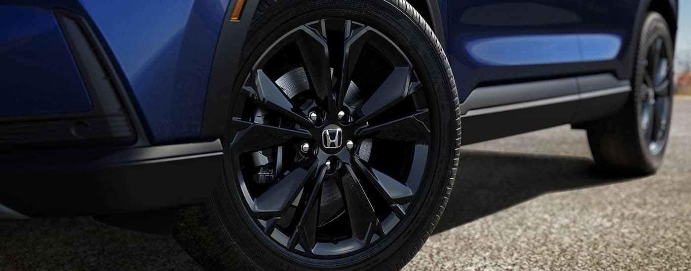 Close-up of the black rim on a blue 2025 Honda CR-V Hybrid