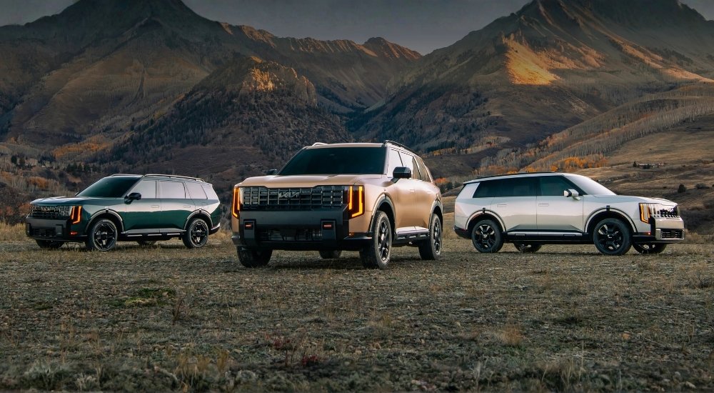 Three 2027 Kia Tellurides parked off-road