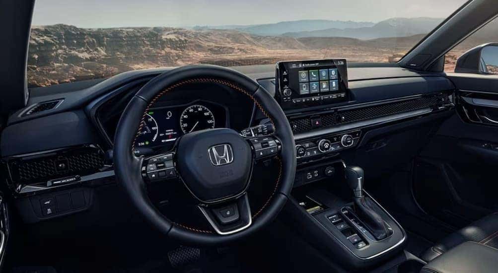 The black interior and dash in a 2025 Honda CR-V is shown.