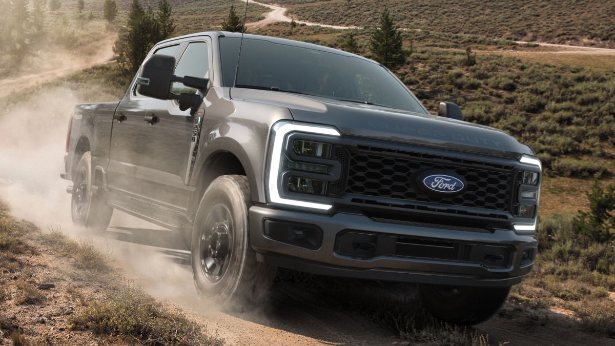 2027 Ford Super Duty pickup kicking up dust on a dirt trail