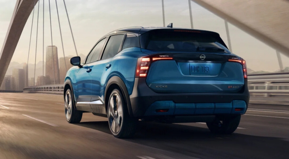 Blue 2026 Nissan Kicks driving on a bridge