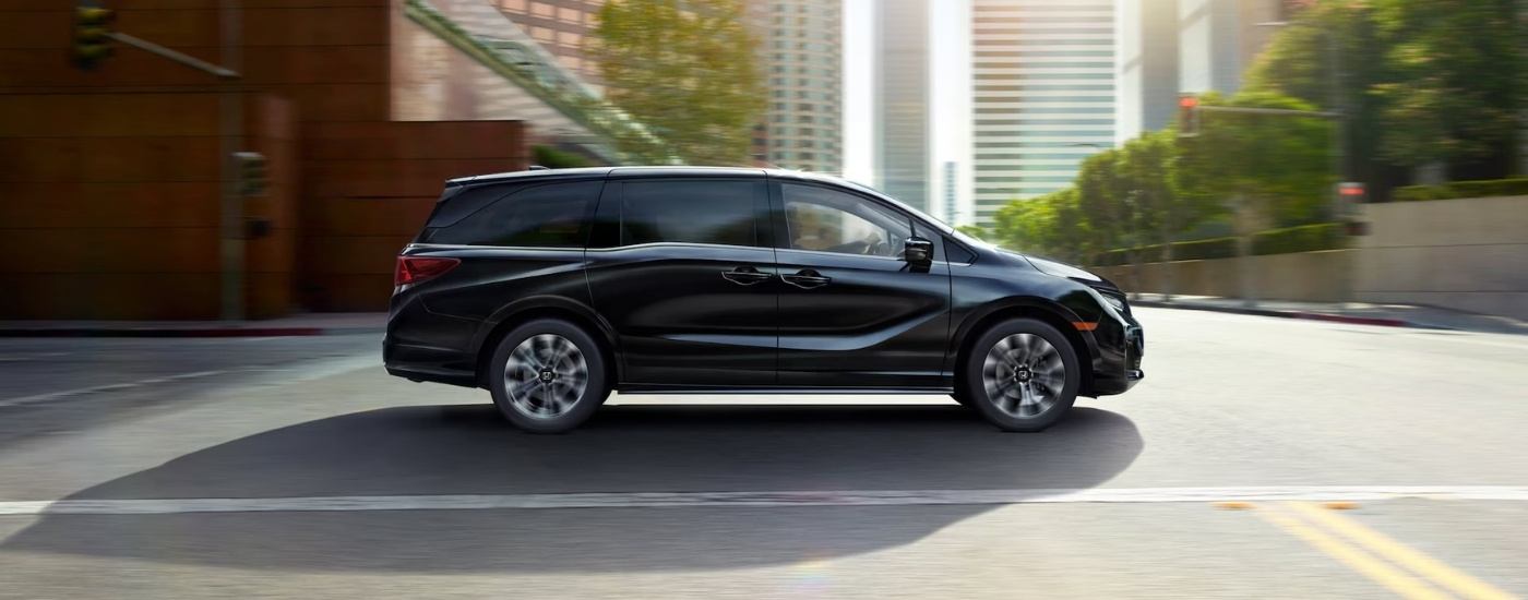 Black 2026 Honda Odyssey driving in a city