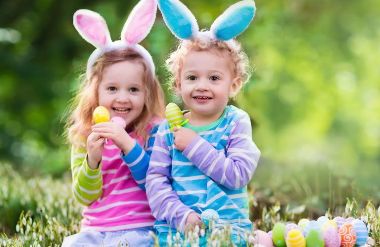 Two Kids with Easter Bunny Ears and Easter Eggs