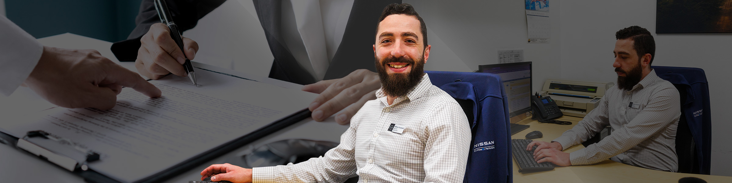 Anthony Pucciarelli, Finance Manager at Boulder Nissan, meeting with a customer and signing paperwork, representing trust and personalized sales guidance.
