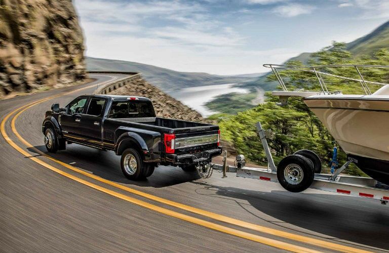 rear view of a black 2021 Ford Super Duty towing a boat