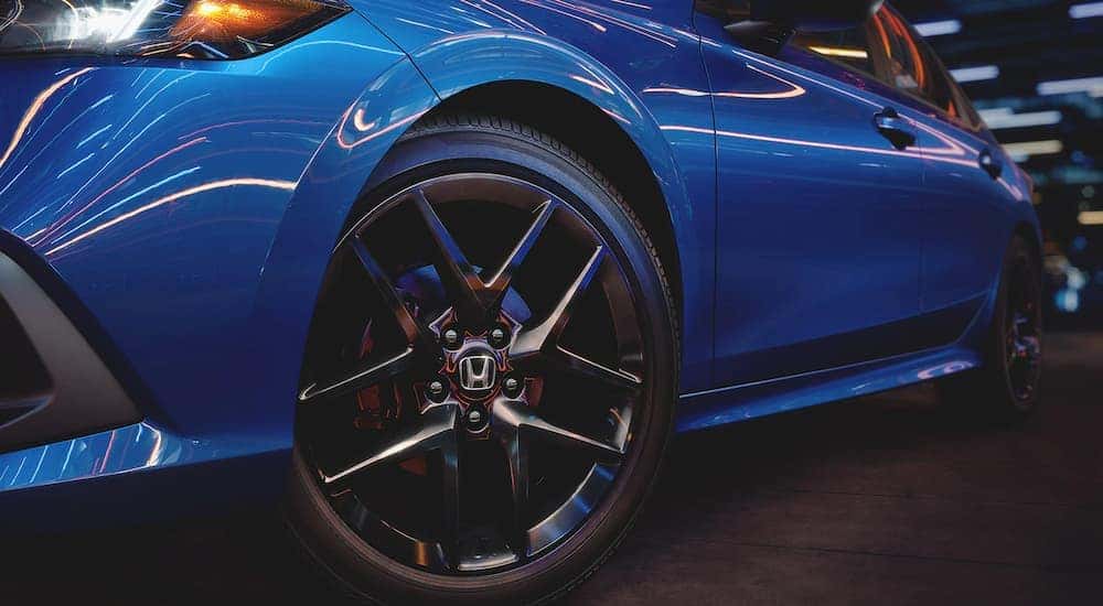 Close-up on the wheel of a blue 2022 Honda Civic.
