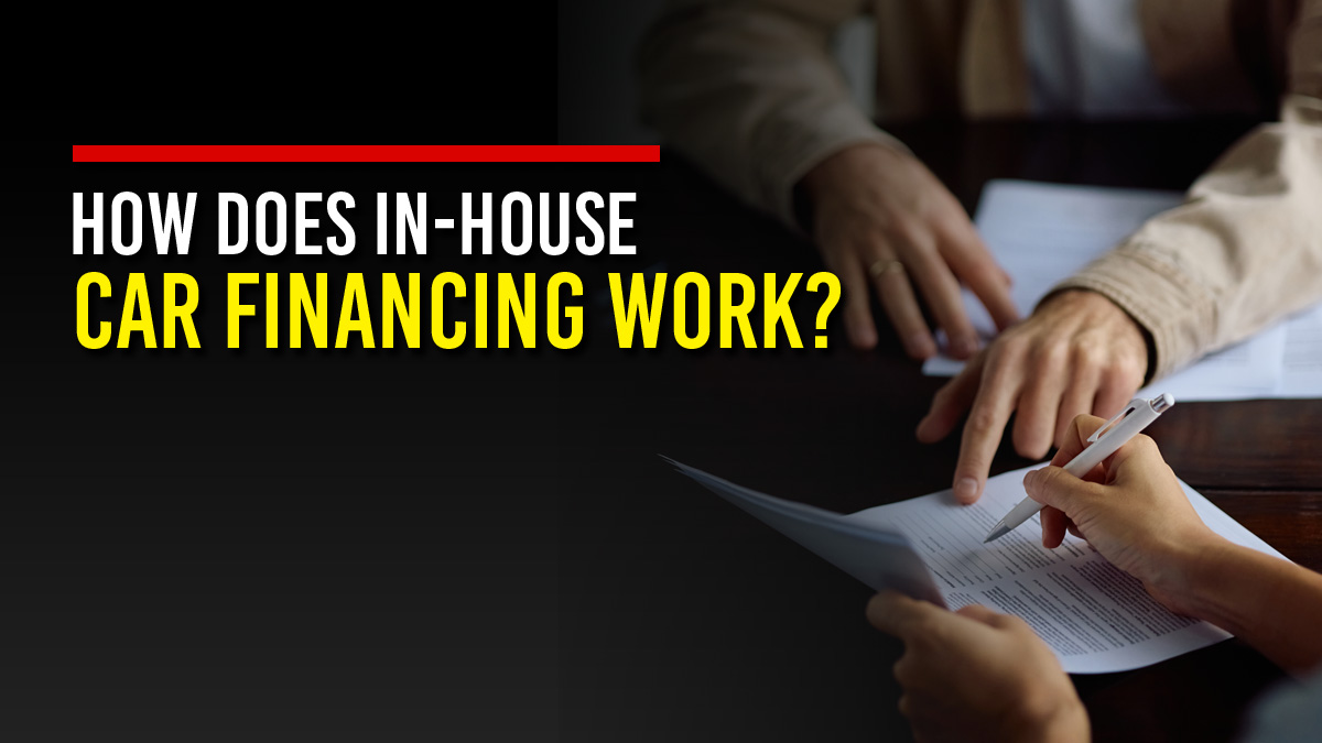 Close-up of a person pointing to a line on a financing contract while a customer holds a pen to sign, next to the headline “How Does In-House Car Financing Work?”