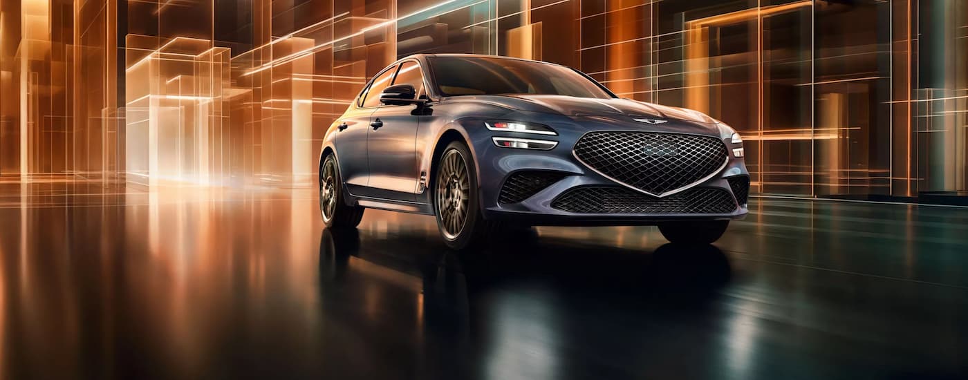 Front image of a grey 2026 Genesis G70 driving in a stylized environment.