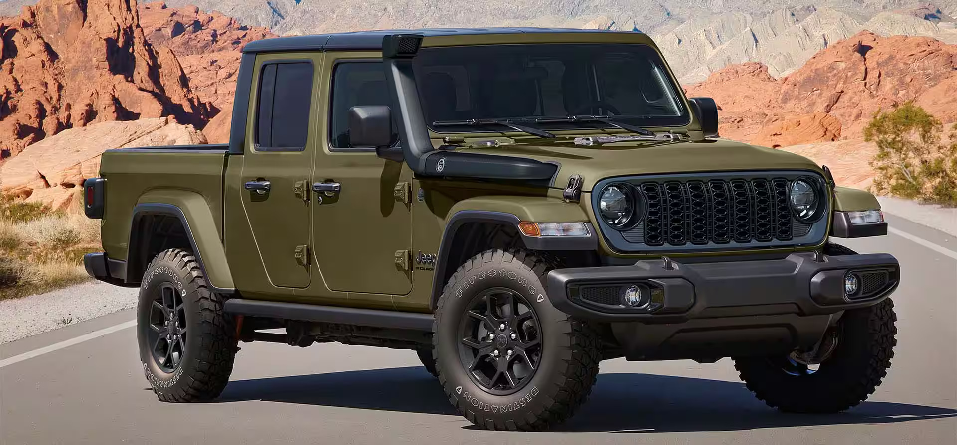 A green jeep parked in the road.