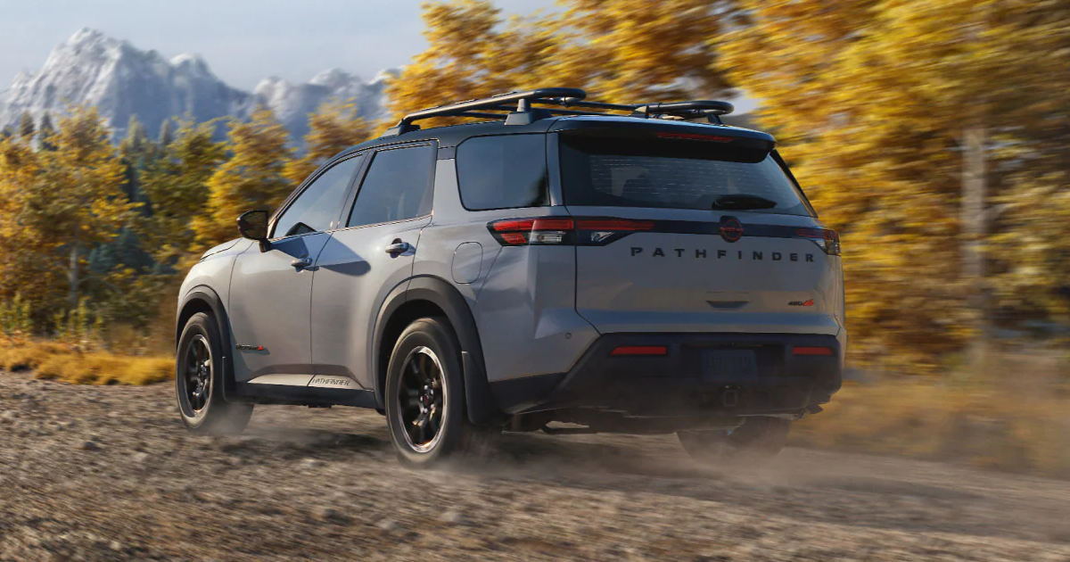 A silver Nissan Pathfinder driving off-road.