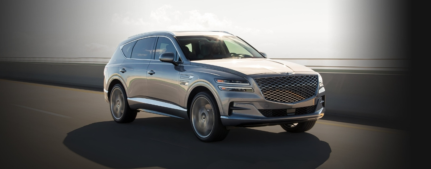 Silver 2020 Genesis GV80 driving on a highway