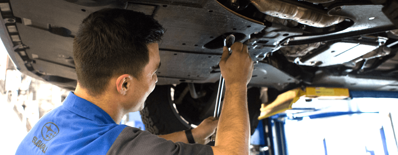 Subaru technician working under a vehicle