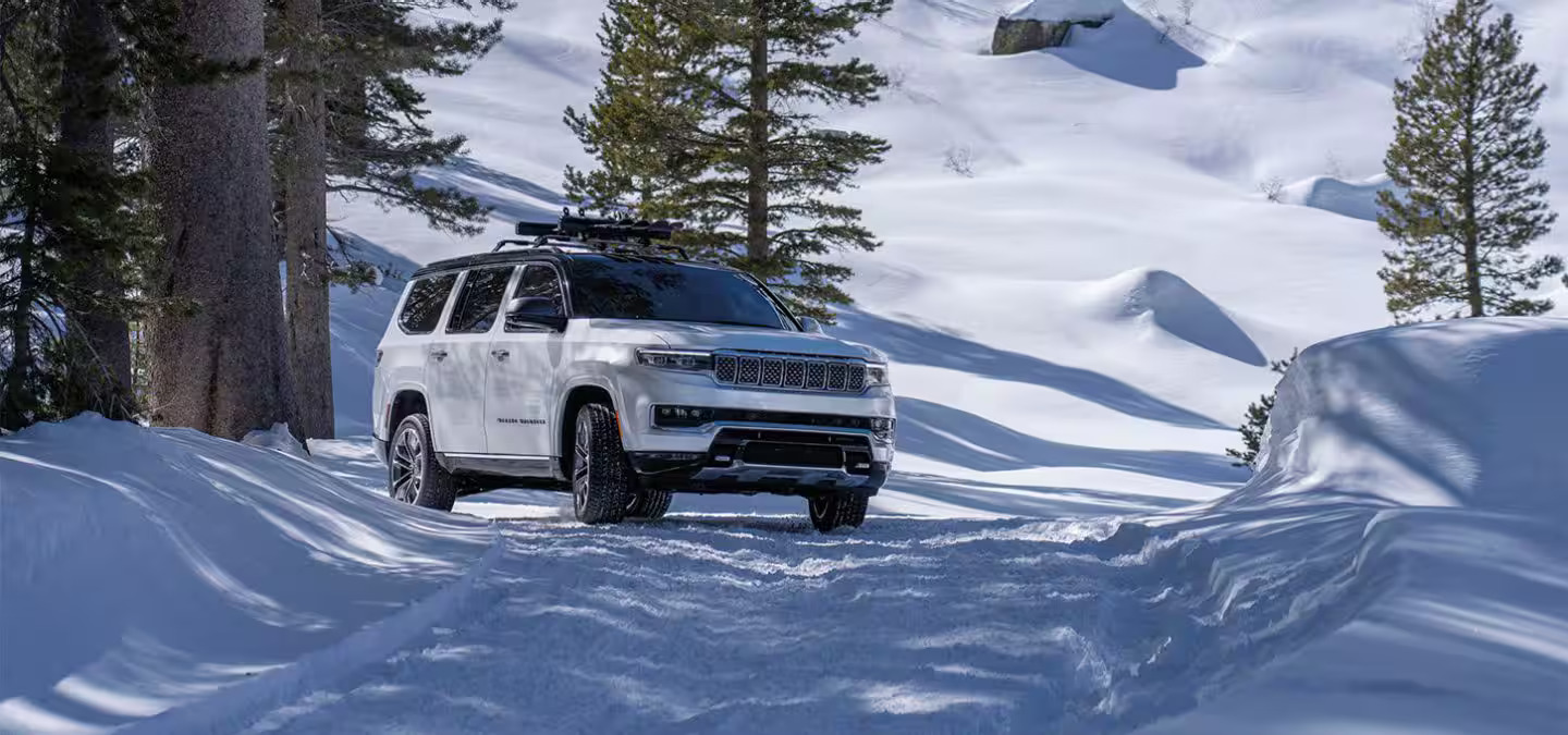 A suv driving in the snow.