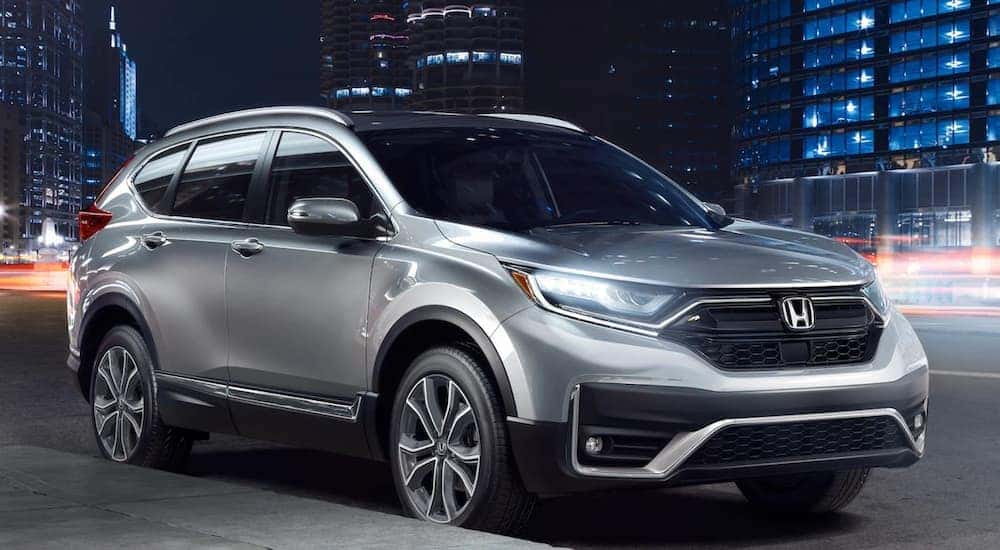 A silver 2021 Honda CR-V Touring is parked on the side of a city street after leaving a Rochester Honda CR-V dealership.