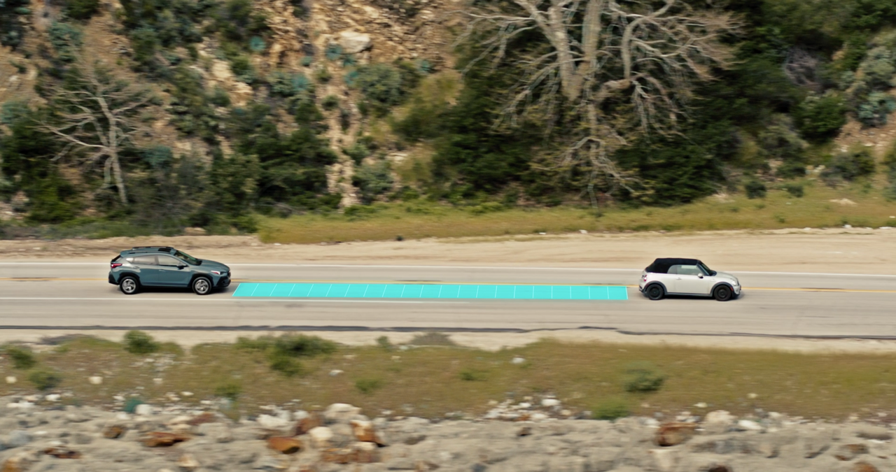 A Subaru Outback drives on a road with a grid representing Advanced Adaptive Cruise Control. 