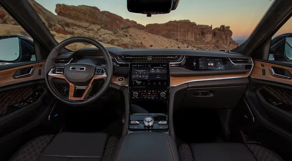 The black and brown interior is shown in a 2024 Jeep Grand Cherokee.