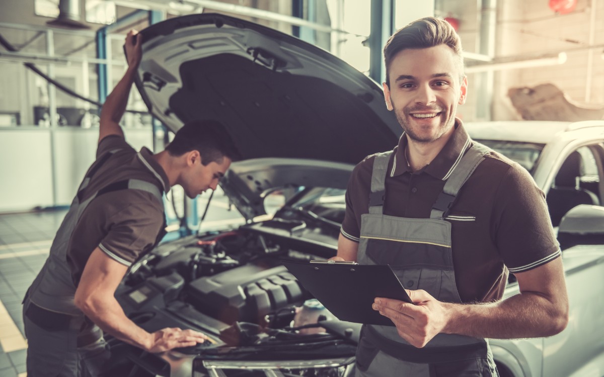 Service Technicians Looking Under Hood