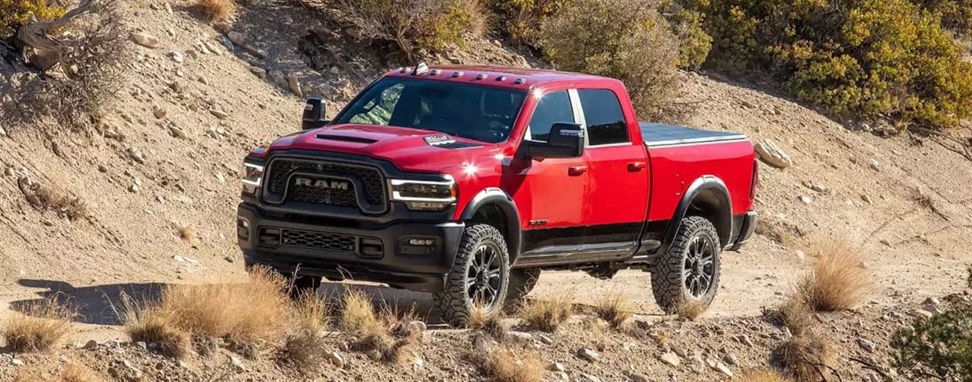 A red 2023 Ram 2500 is shown from the front at an angle.