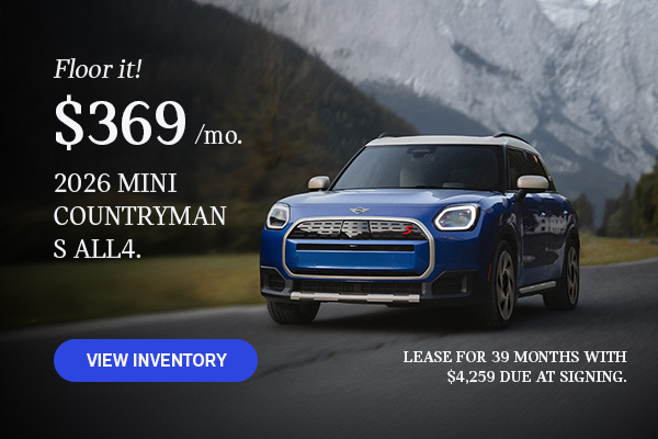 Front view of a blue MINI Countryman  driving on a mountainous road.
