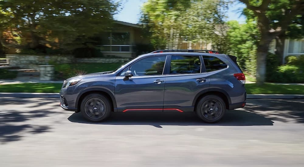 Side view of a 2024 Subaru Forester driving.