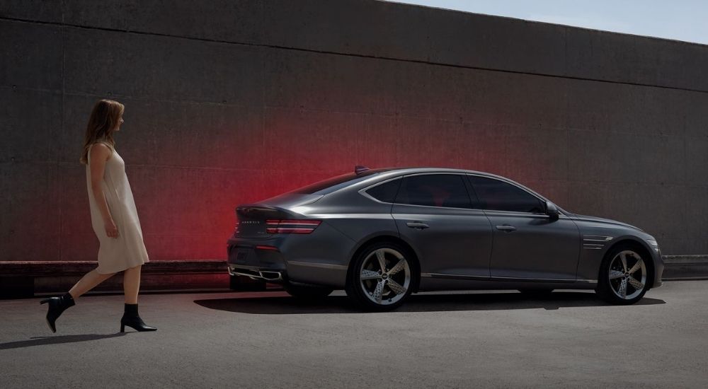 Grey 2024 Genesis G80 parked near a wall