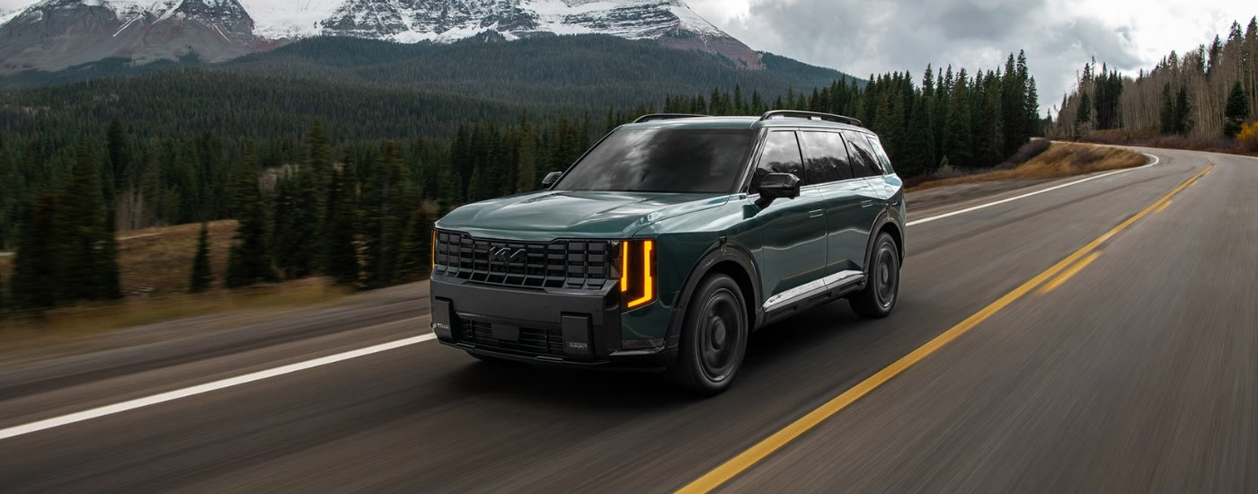 Green 2027 Kia Telluride for sale in Glendale driving on a highway