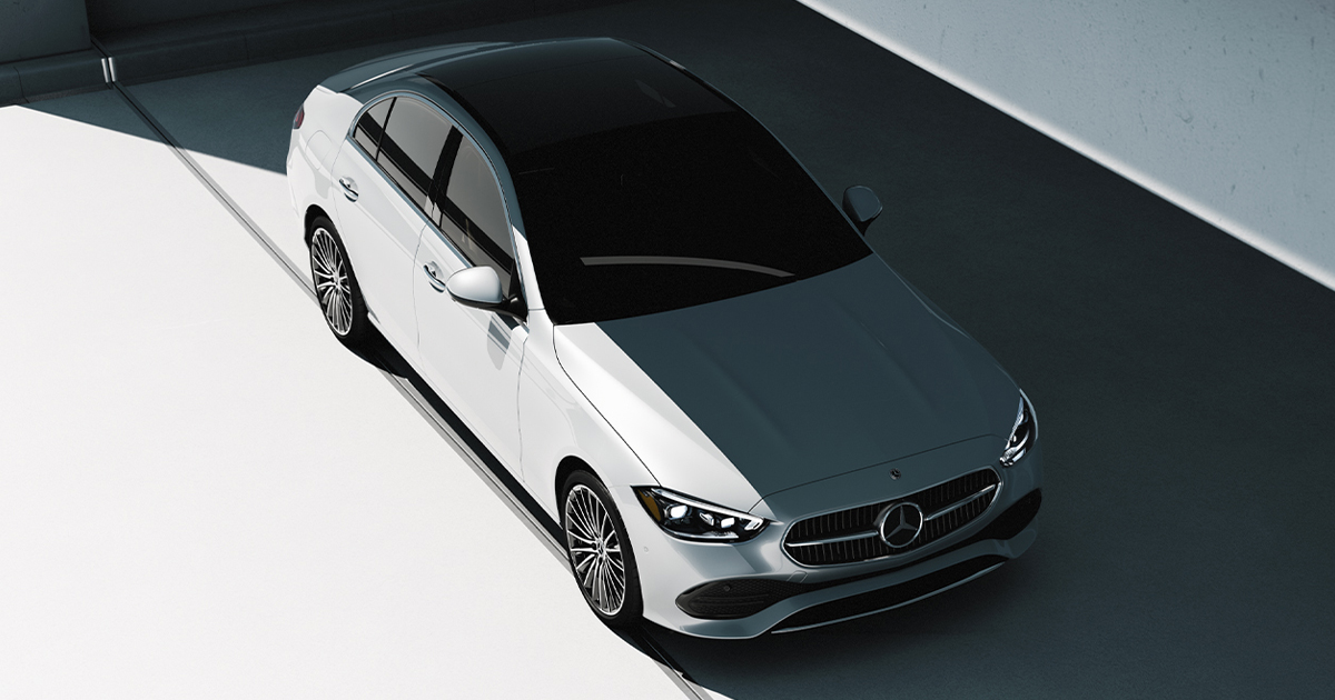 A white Mercedes-Benz C-Class sedan