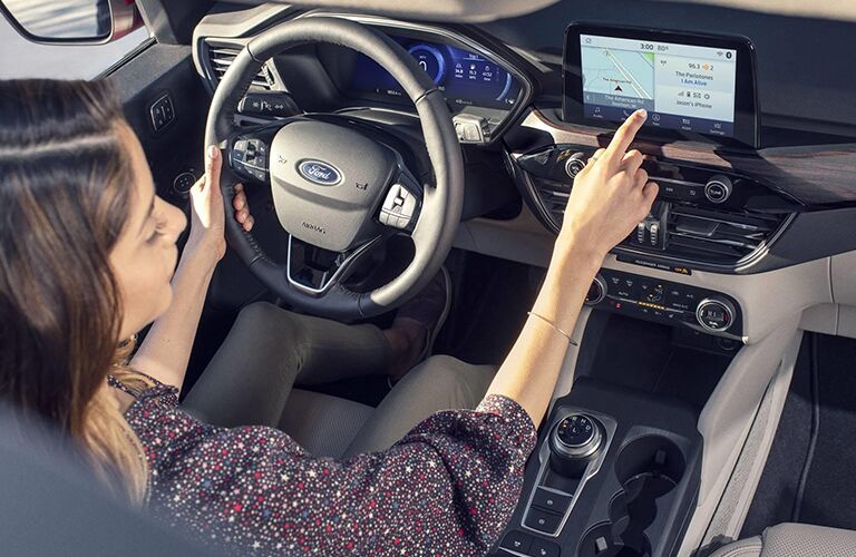 woman using infotainment system in her 2021 Ford Escape