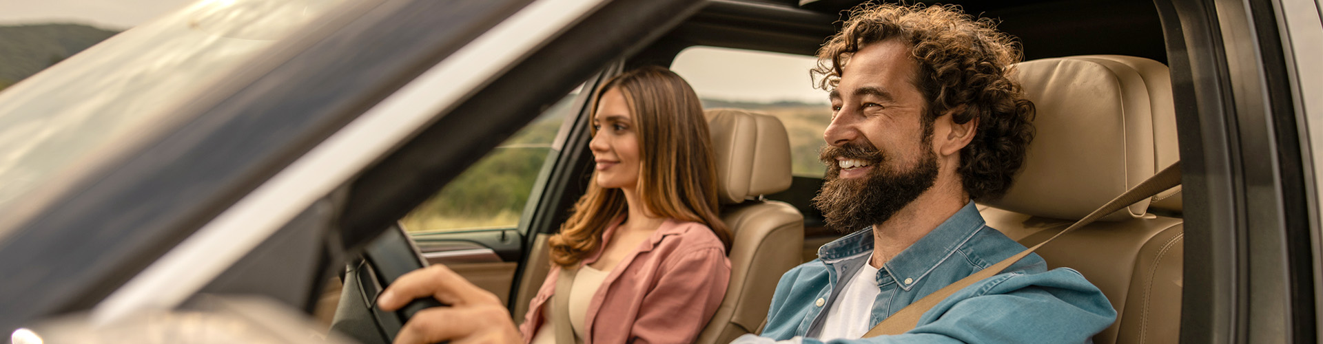 Happy customers driving off in their car