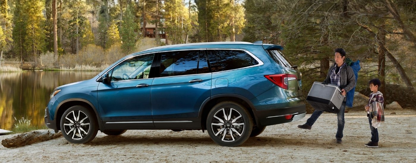 Blue 2022 Honda Pilot Elite parked near a lake