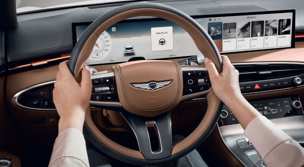 Black and brown leather steering wheel in a 2026 Genesis GV70