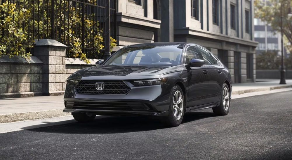 Grey 2026 Honda Accord Hybrid parked on a city street.