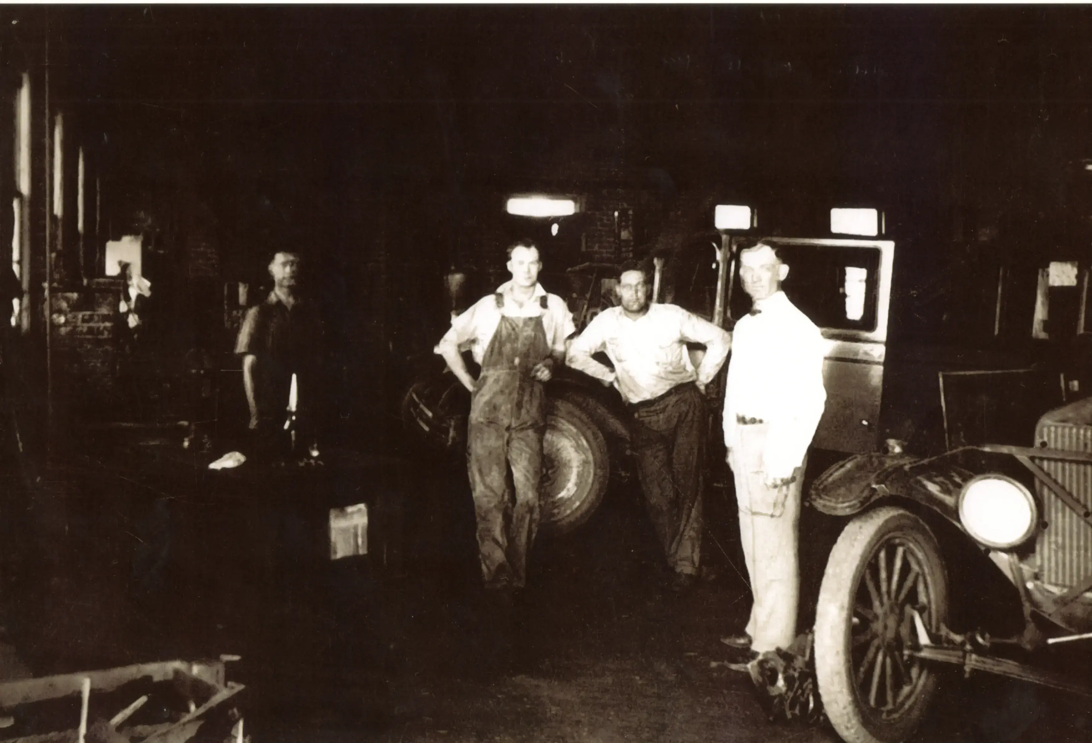 Claude Cooper working on a car engine in 1946